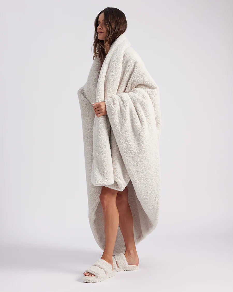 girl wrapped up with a white throw blanket