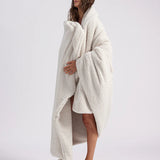girl wrapped up with a white throw blanket