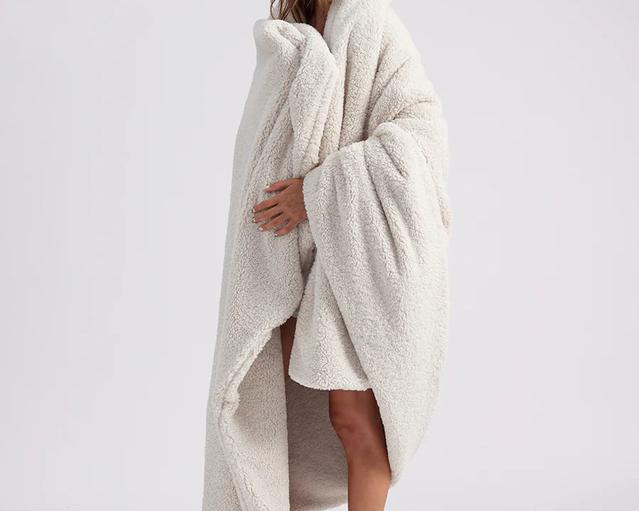 girl wrapped up with a white throw blanket