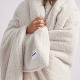 girl wrapped up with a white throw blanket