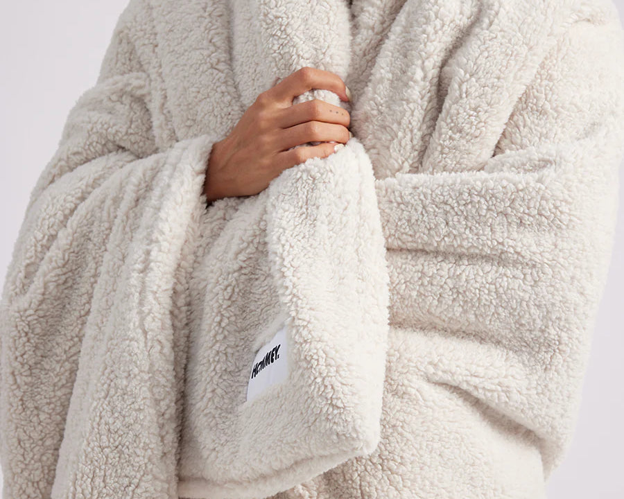 girl wrapped up with a white throw blanket