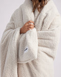 girl wrapped up with a white throw blanket