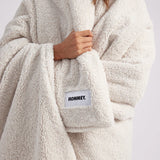 close up shot of girl wrapped up with a white throw blanket