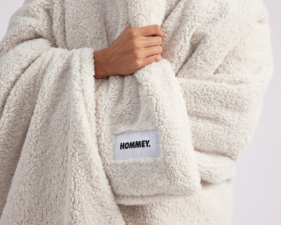 close up shot of girl wrapped up with a white throw blanket