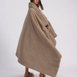 girl with throw blanket over her up close