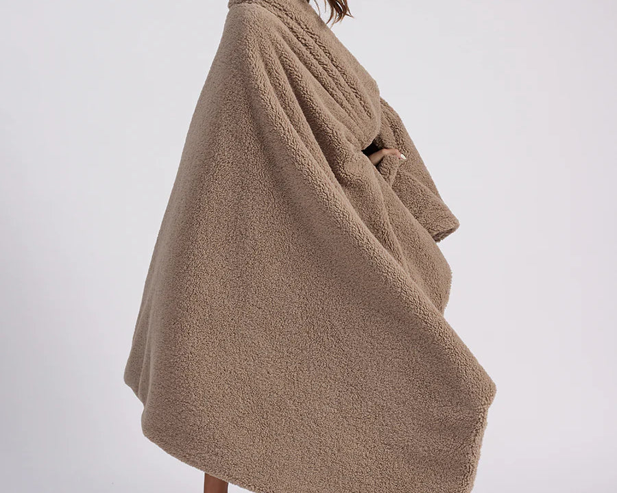 girl with throw blanket over her up close