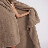 girl with throw blanket over her up close