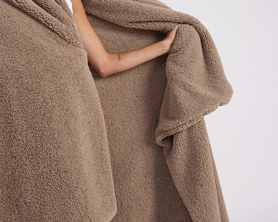 girl with throw blanket over her up close