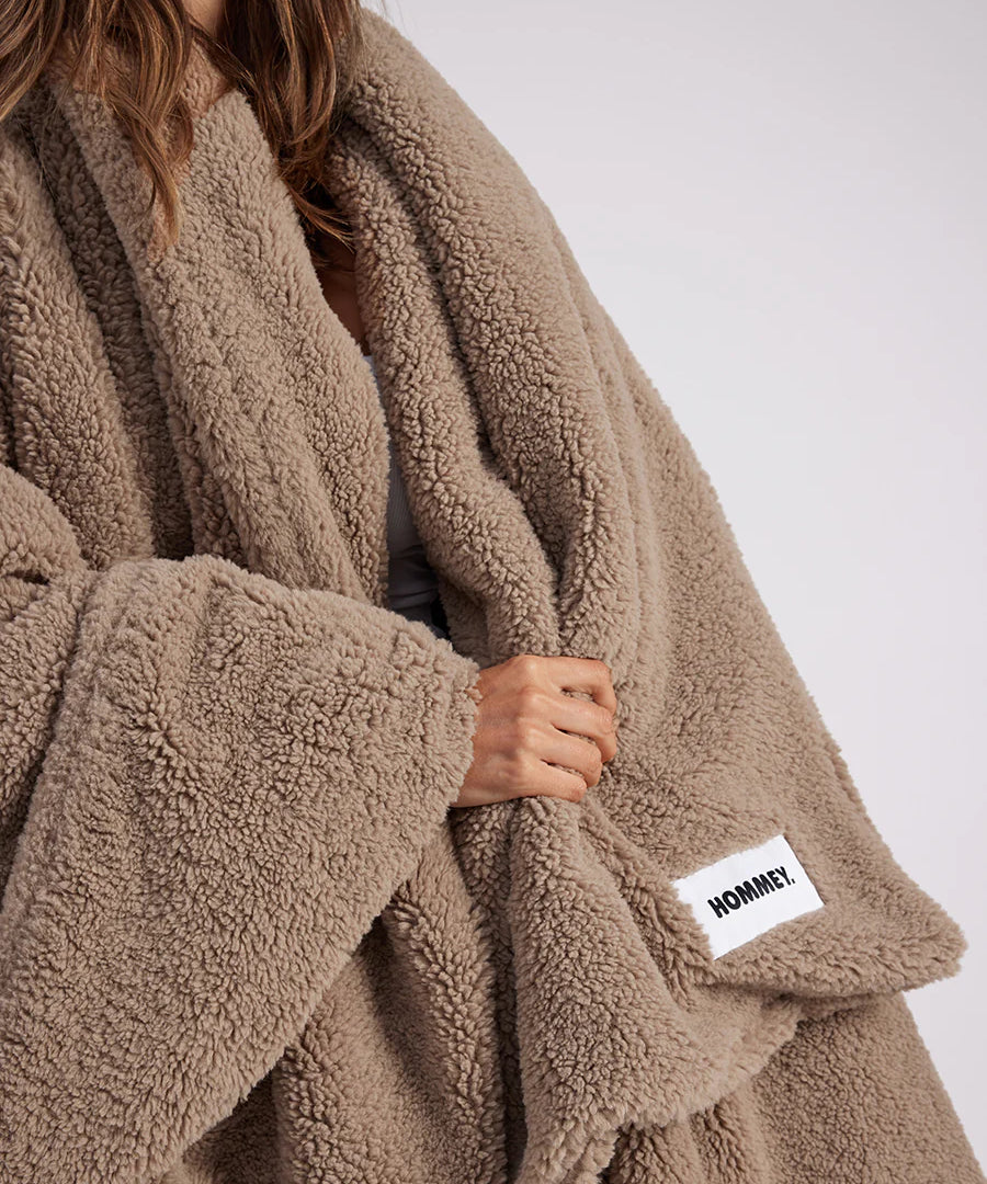 girl with throw blanket over her up close