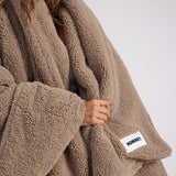 girl with throw blanket over her up close