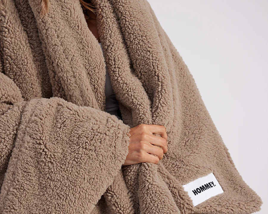 girl with throw blanket over her up close