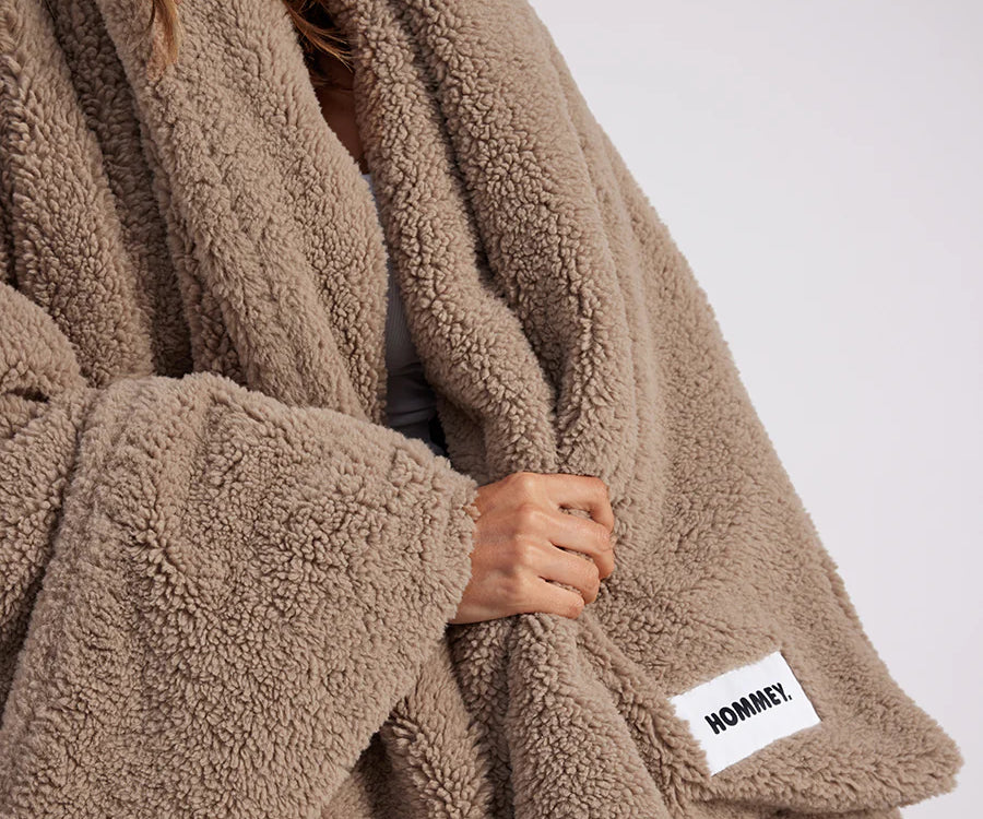 girl with throw blanket over her up close