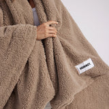 girl with throw blanket over her up close