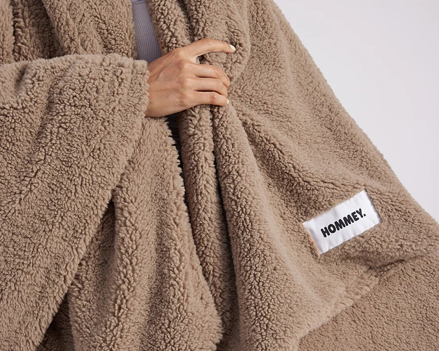 girl with throw blanket over her up close