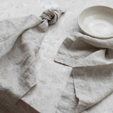 beige linen napkins sitting on a marble table