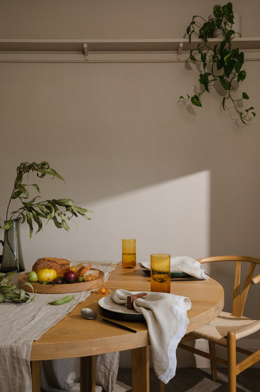 table set with food and napkins with sun shining through 