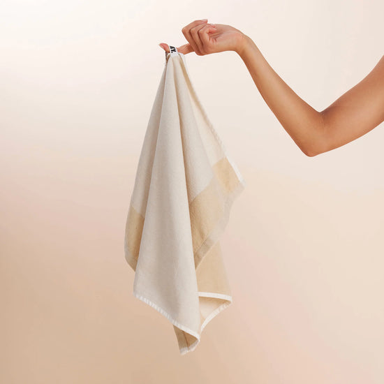 girl holding white tea towel up