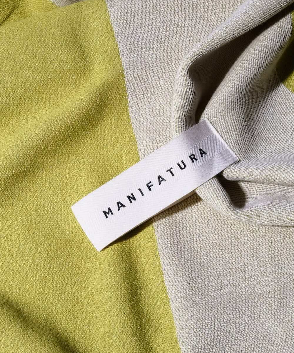 up close picture of a pistachio green and white beach towel