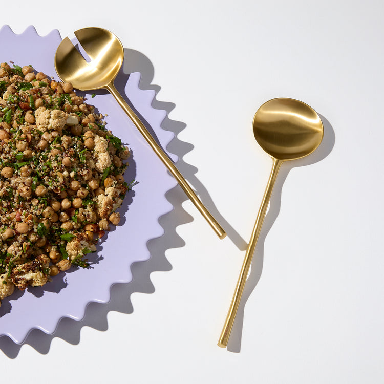 wave salad servers on a plate