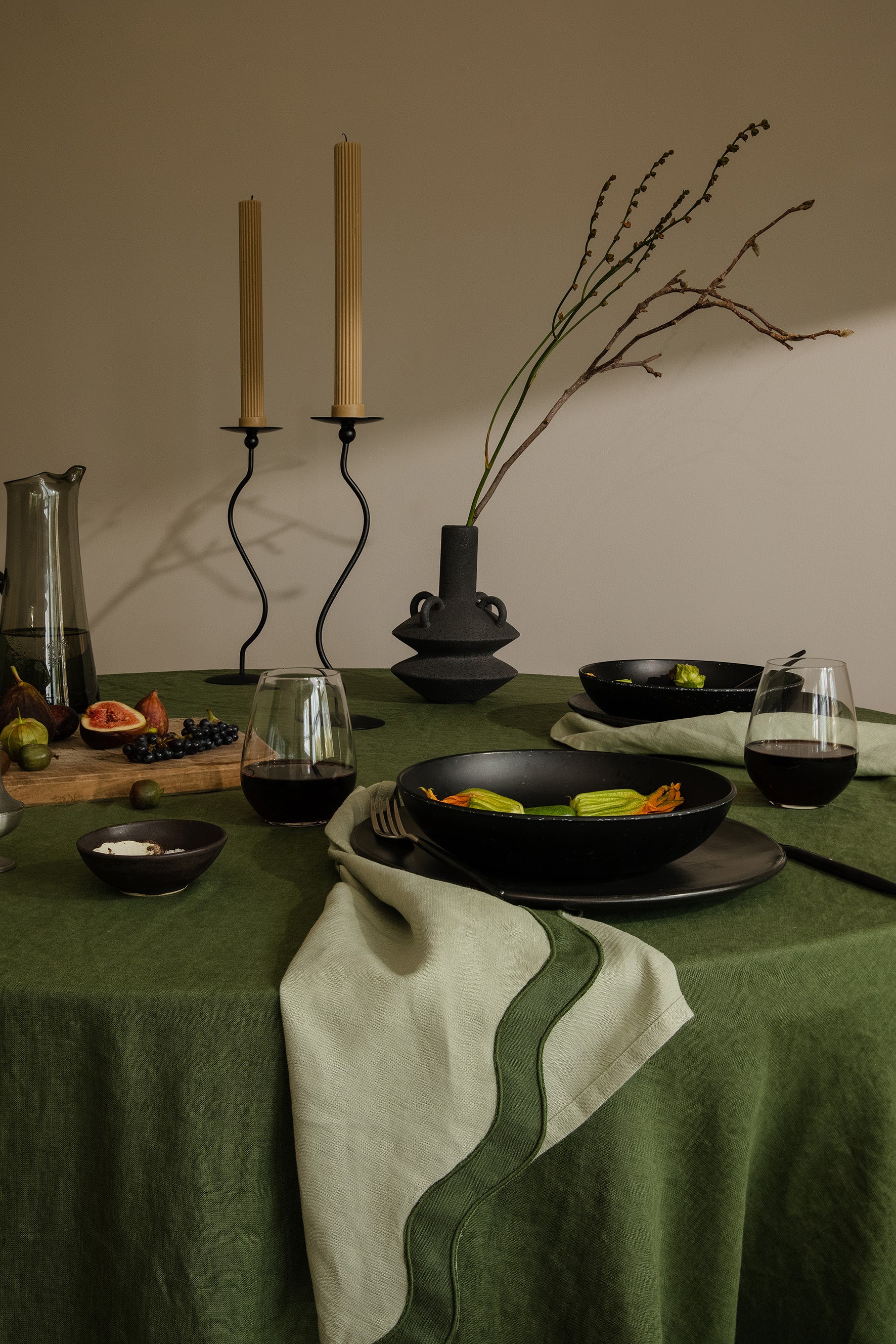 tablescape of food, napkins and other items sitting on table with a green theme 