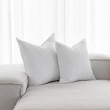 white linen cushions sitting on a couch