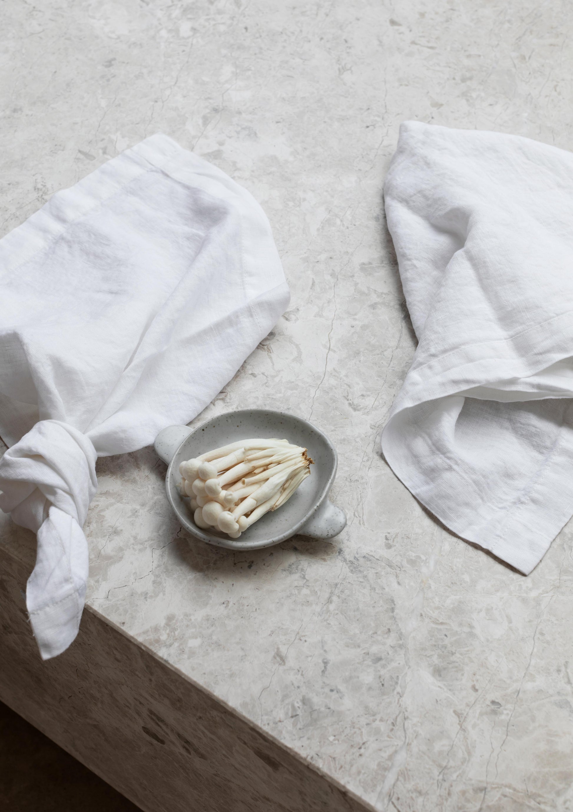 white napkins sitting on a marble table