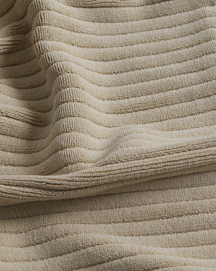 up close picture of texture of beige bath mat