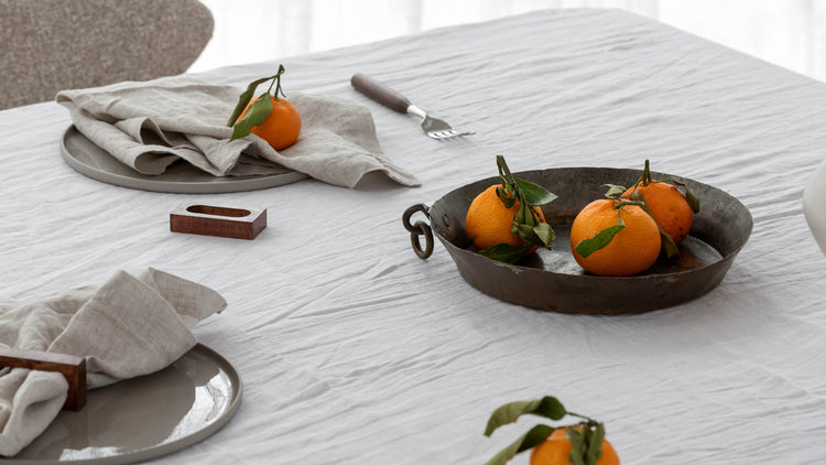 tablescape of napkins, ceramics and food sitting on a table 