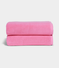 Soft pink bath towel folded neatly for spa-like comfort at home