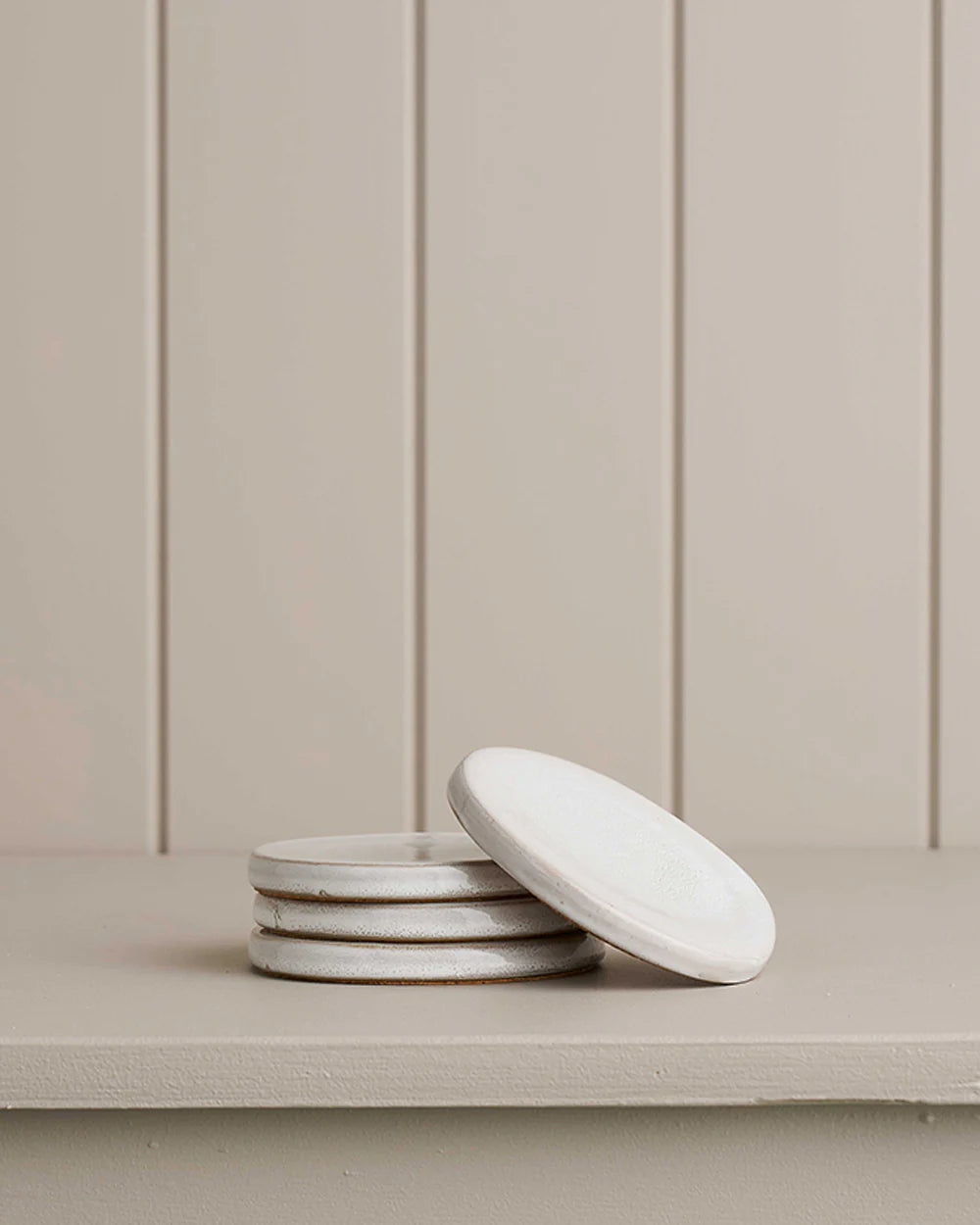 coasters sitting on a wooden shelf