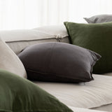 different coloured linen cushions scattered on a couch