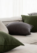 different coloured linen cushions scattered on a couch