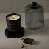 lifestyle shot of candle and glass dome sitting together
