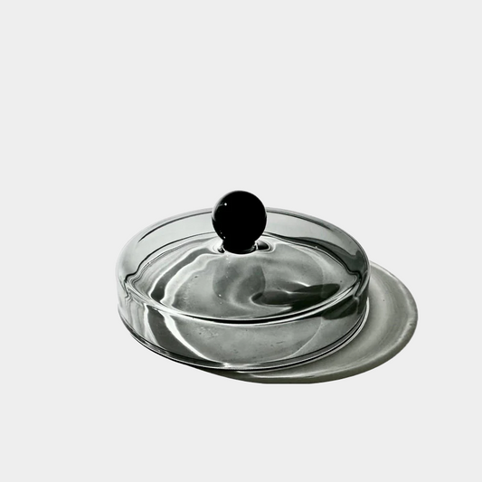 glass candle lid sitting on a table 