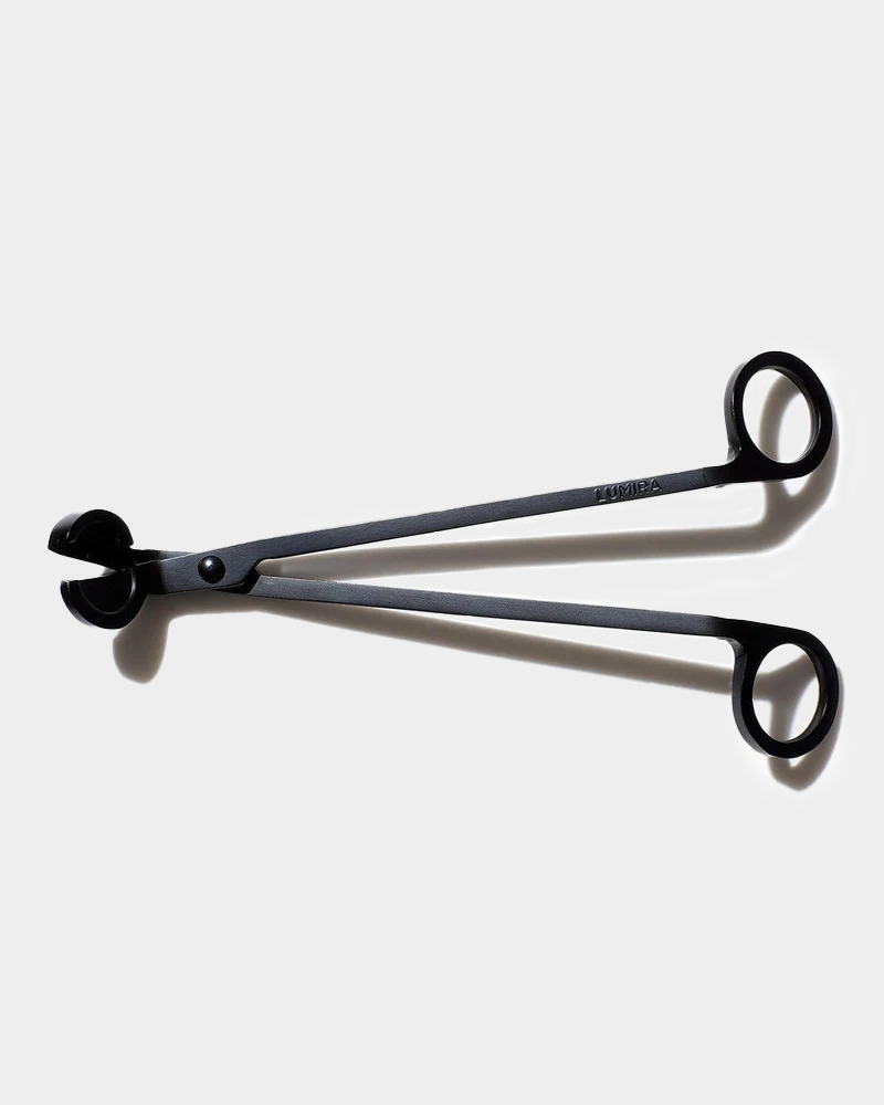 wick trimmer sitting on white background