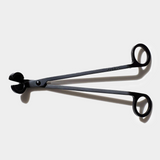 wick trimmer sitting on white background