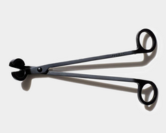 wick trimmer sitting on white background