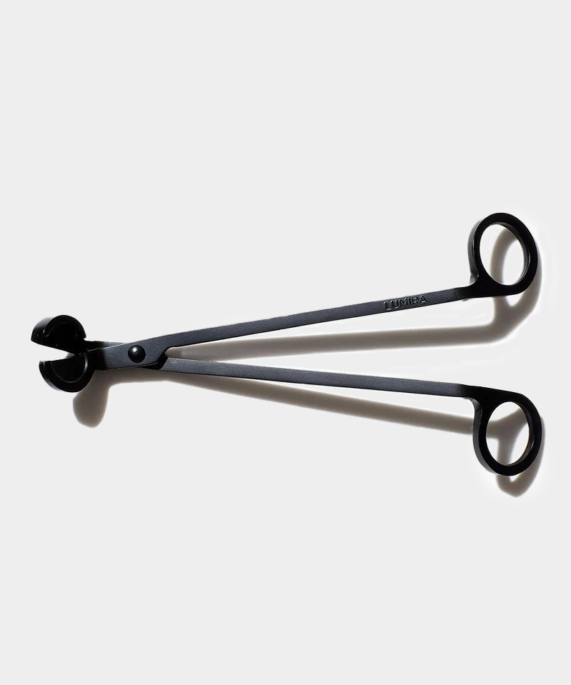 wick trimmer sitting on white background