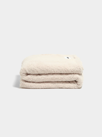 white fluffy throw blanket sitting on white background