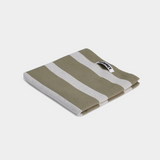 green and grey striped tea towel on white background