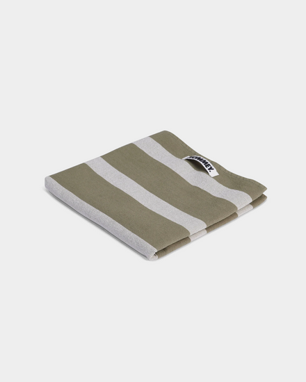 green and grey striped tea towel on white background