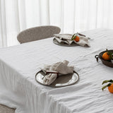 tablescape of napkins, ceramics and food sitting on a table 
