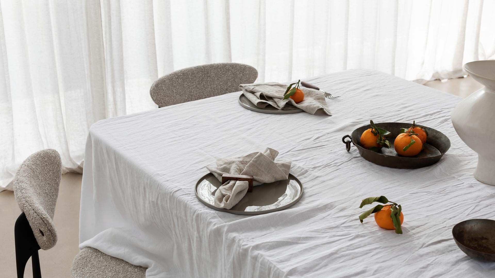 tablescape of napkins, ceramics and food sitting on a table 