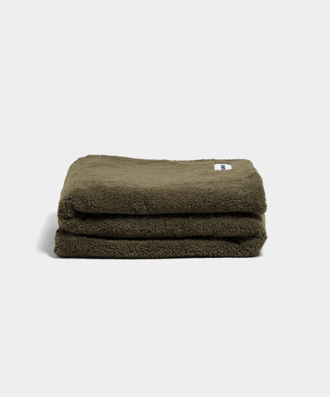 green fluffy throw blanket on white background