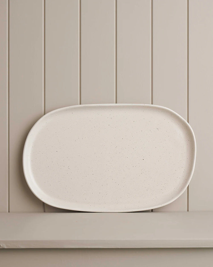 white large oblong platter on wooden shelf