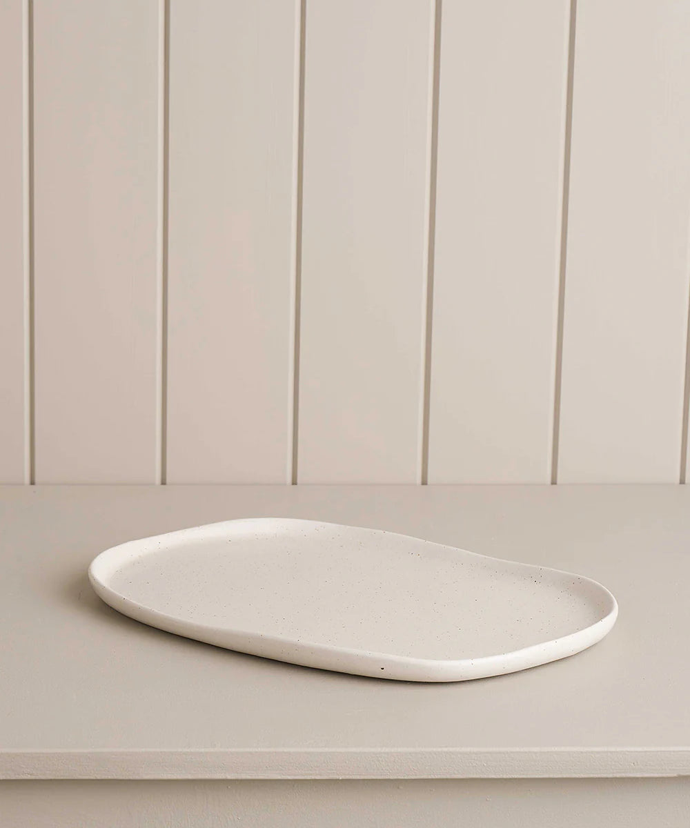 white small oblong platter on wooden shelf