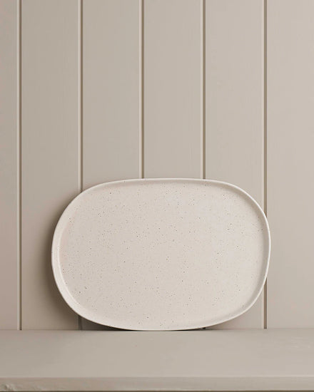 white small oblong platter on wooden shelf