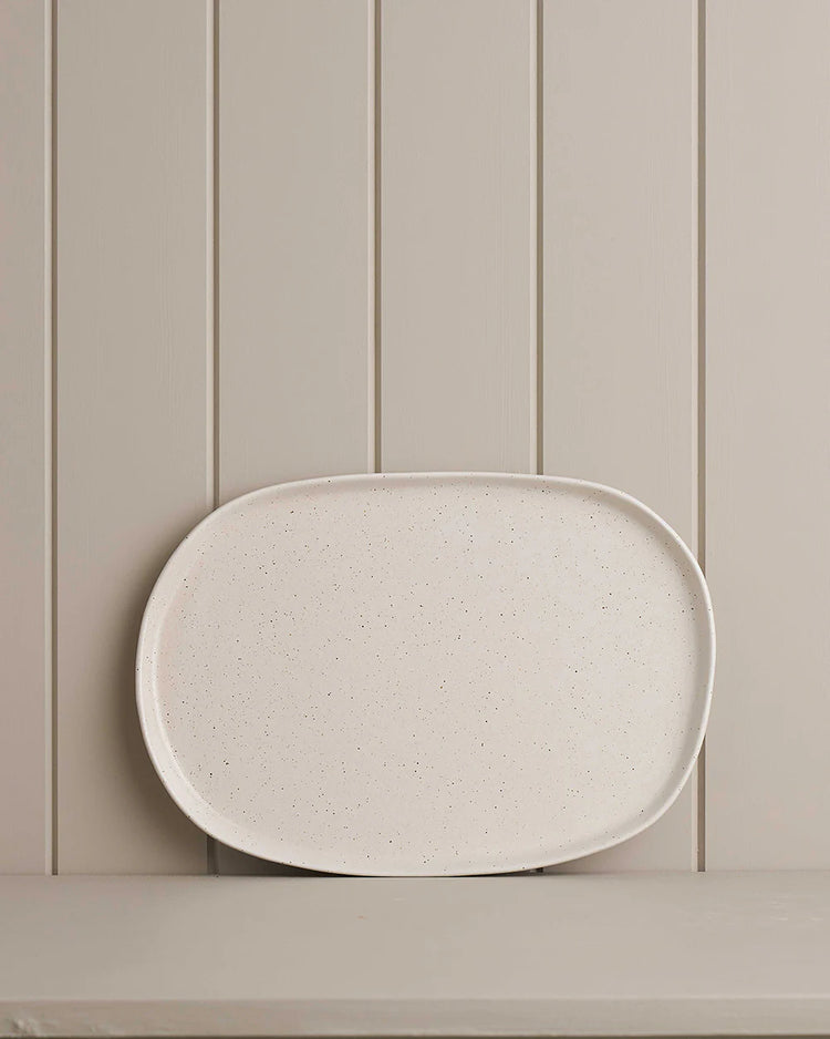 white small oblong platter on wooden shelf