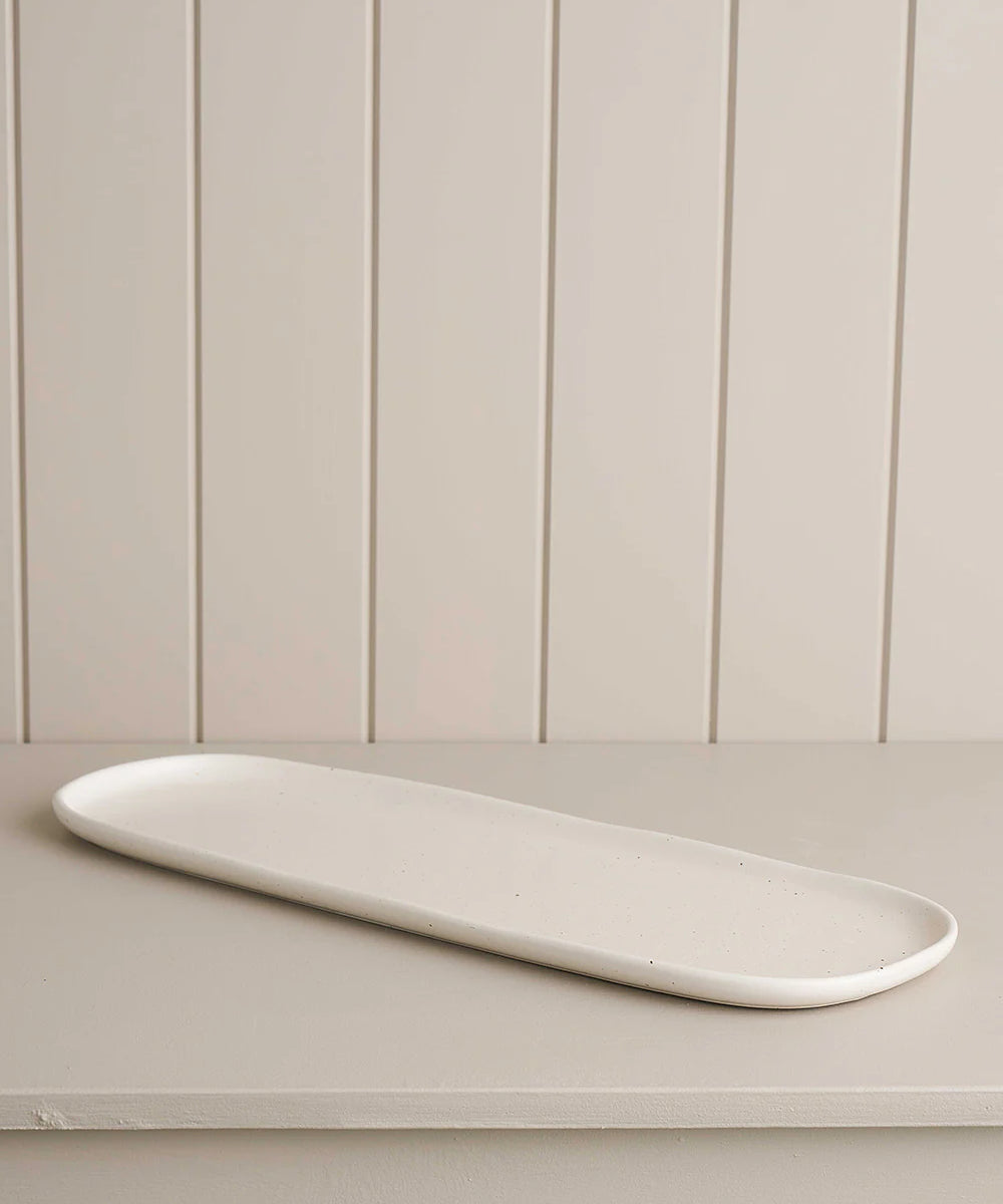 long platter on a wooden shelf 