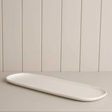 long platter on a wooden shelf 